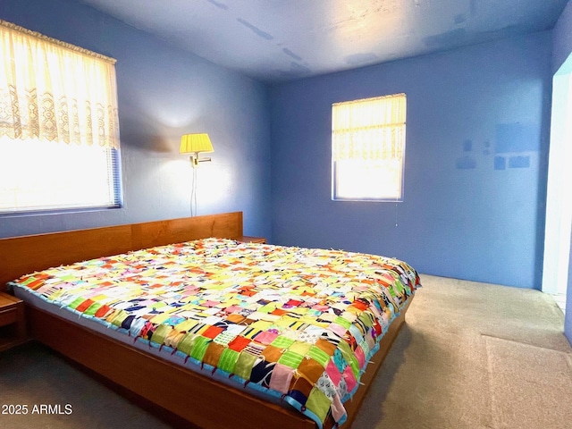 carpeted bedroom featuring multiple windows