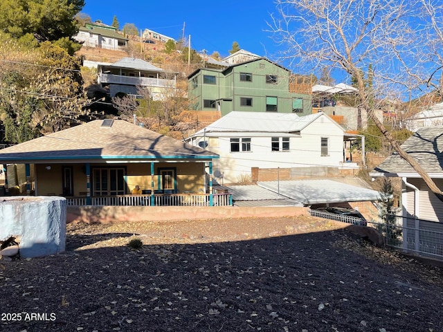 back of house featuring a porch