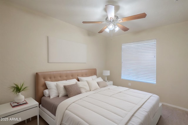 bedroom featuring ceiling fan and carpet