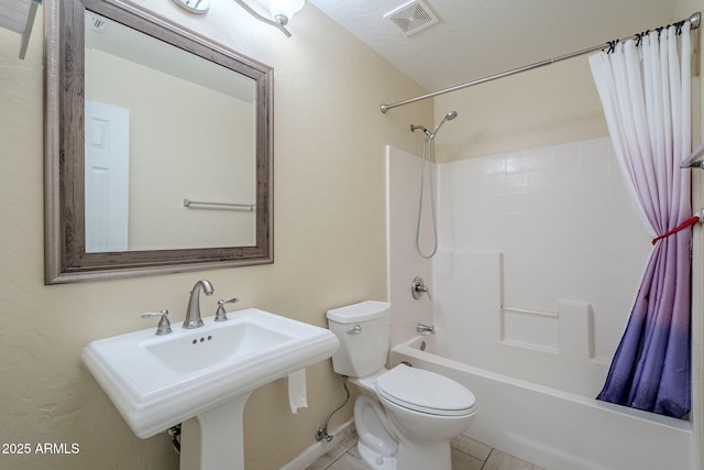 full bathroom with sink, shower / bath combo, toilet, and tile patterned flooring