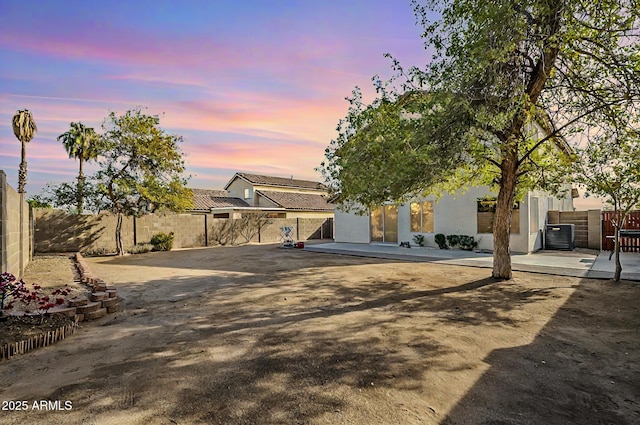 view of front of property featuring central air condition unit and a patio area