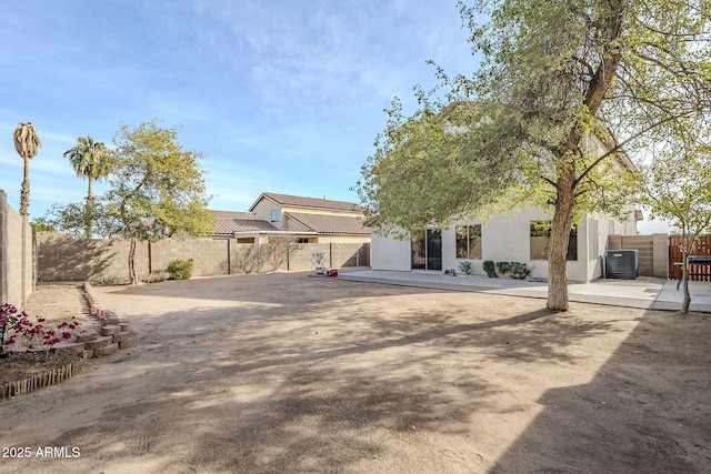 view of front of home with a patio area and cooling unit