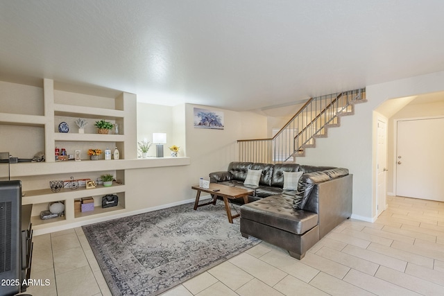 tiled living room featuring built in features and heating unit