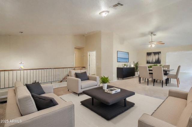 living room with ceiling fan, light carpet, and vaulted ceiling