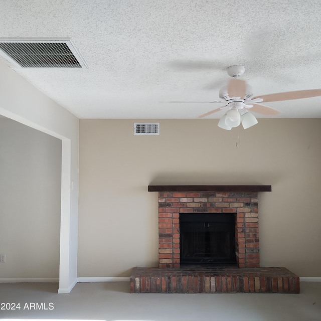 interior details with a brick fireplace, a textured ceiling, and ceiling fan