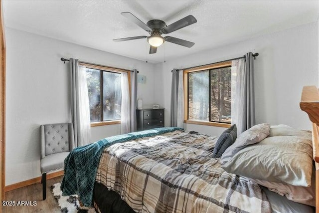 bedroom with ceiling fan and hardwood / wood-style floors