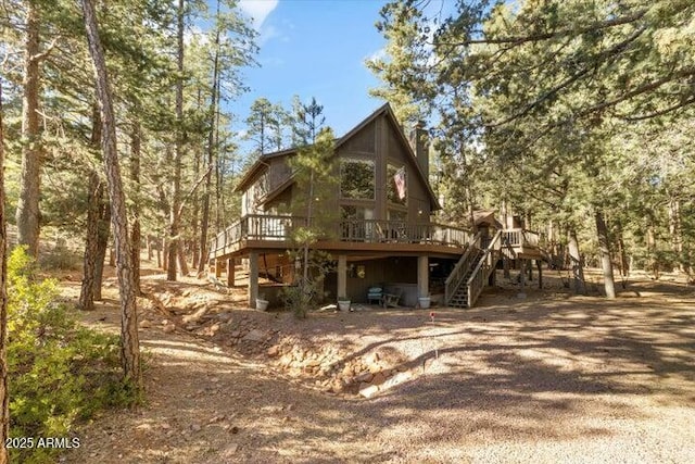 back of property with a wooden deck