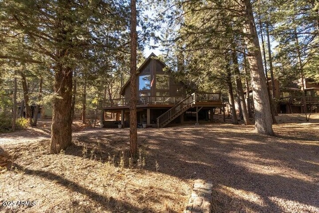 back of property featuring a wooden deck