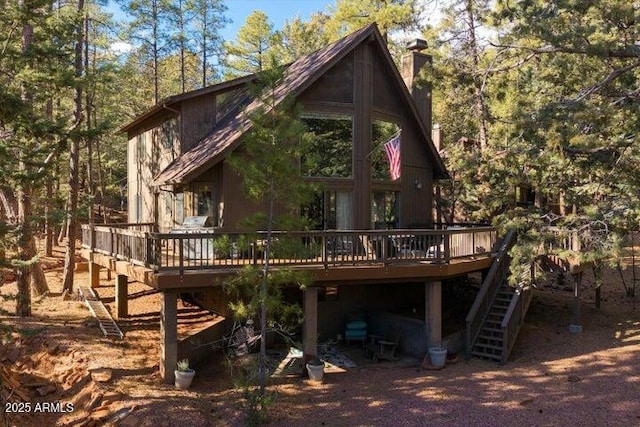 back of property with a wooden deck