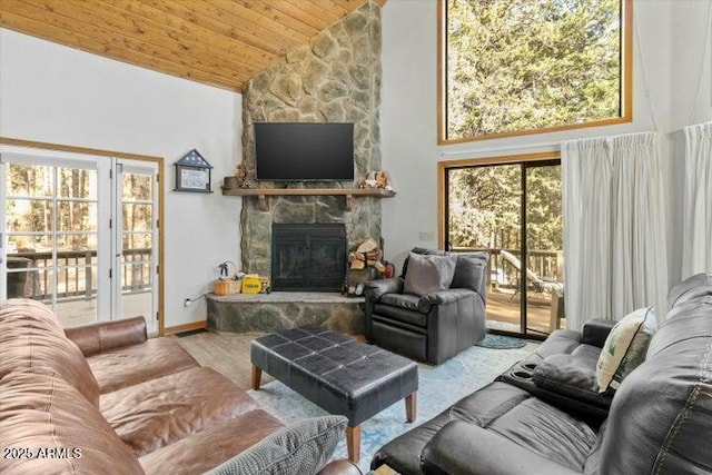 living room featuring high vaulted ceiling, a fireplace, wood ceiling, and hardwood / wood-style floors