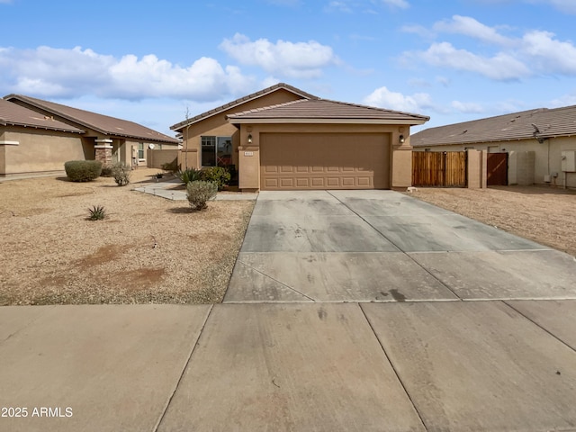 ranch-style house featuring stucco siding, concrete driveway, an attached garage, fence, and a tiled roof