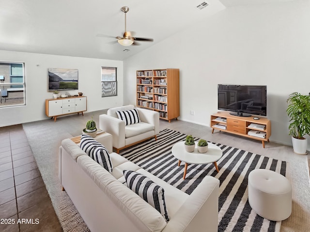 living area with lofted ceiling, visible vents, and a ceiling fan