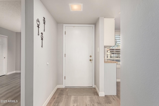 interior space featuring light hardwood / wood-style floors and a textured ceiling