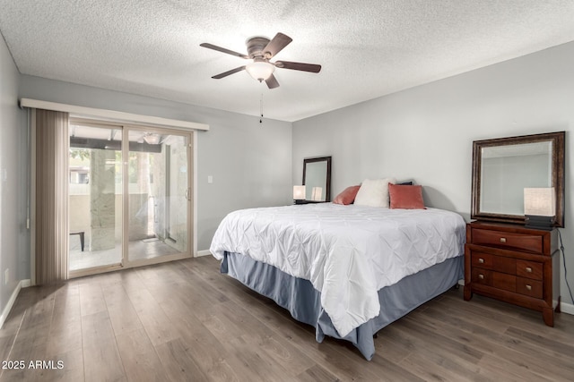 bedroom featuring ceiling fan, access to outside, a textured ceiling, and hardwood / wood-style flooring