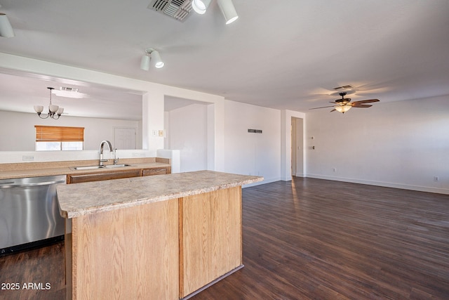 kitchen featuring dark wood-style flooring, light countertops, visible vents, a sink, and dishwasher