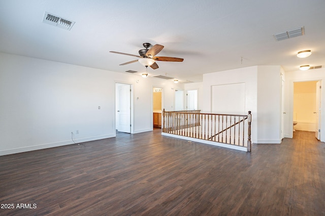 spare room with visible vents and dark wood-style flooring