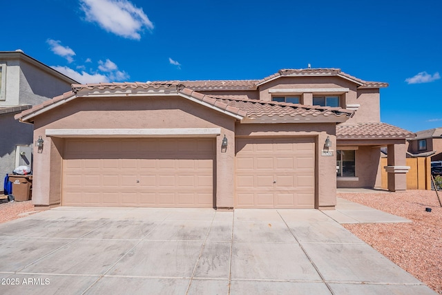 view of front of property with a garage, driveway, a tile roof, and stucco siding