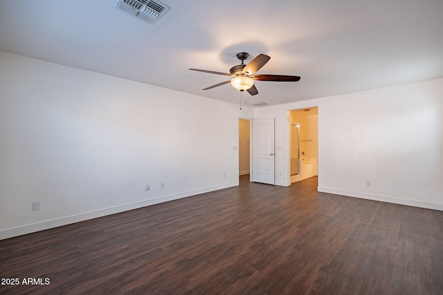 spare room featuring a ceiling fan, baseboards, visible vents, and dark wood-style flooring