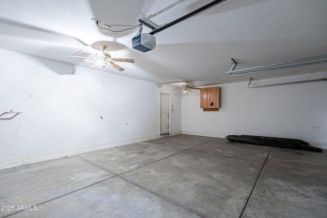 garage featuring a garage door opener and baseboards