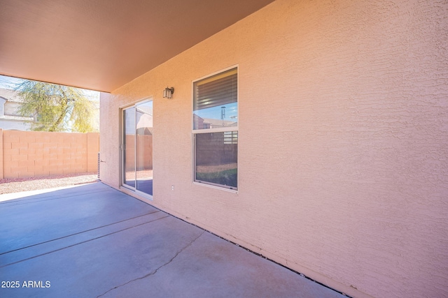 view of patio featuring fence