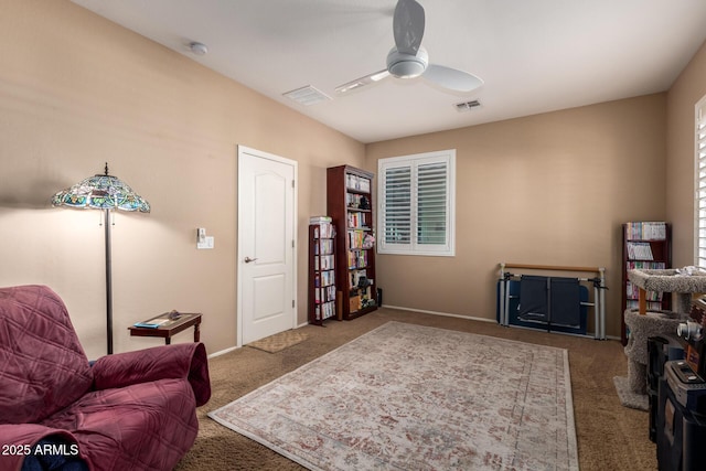 sitting room featuring ceiling fan and carpet