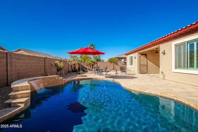 view of swimming pool with ceiling fan, a patio, and pool water feature