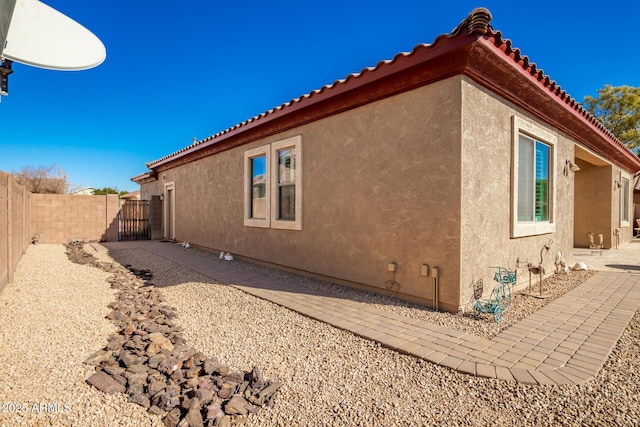 view of side of property featuring a patio