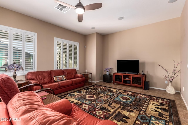 living room featuring ceiling fan and tile patterned floors