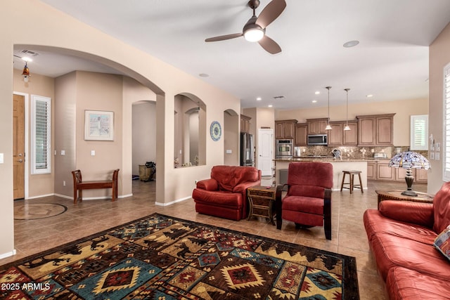 tiled living room with ceiling fan