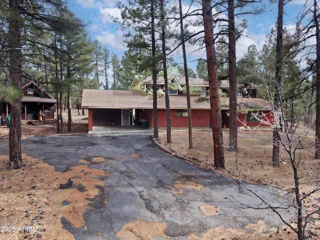 view of front of property with aphalt driveway and an attached carport