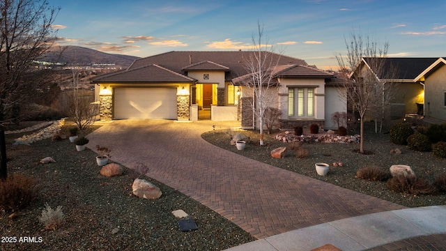 view of front of house with a mountain view and a garage