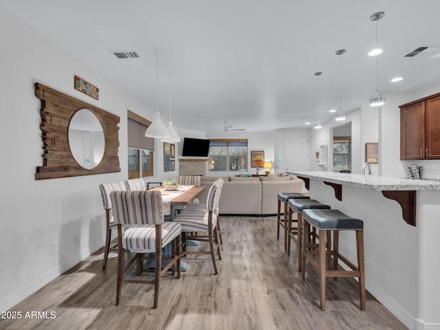 2882 W Presidio Dr, Flagstaff, AZ 86001 - dining area with light wood-style flooring, visible vents, and baseboards