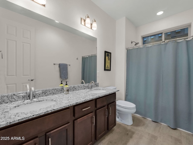 2882 W Presidio Dr, Flagstaff, AZ 86001 - bathroom featuring double vanity, toilet, and a sink