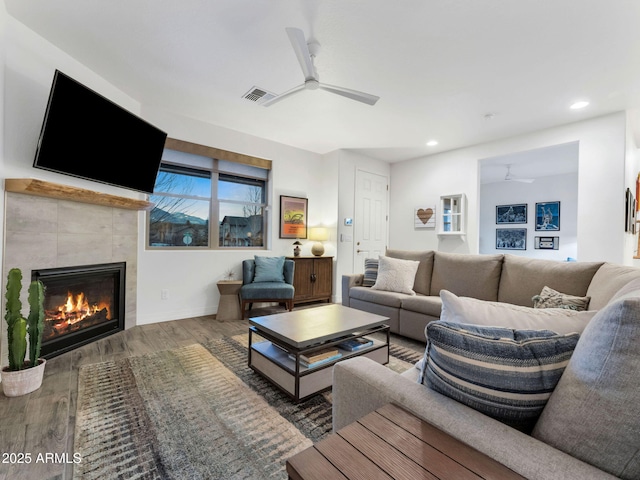 2882 W Presidio Dr, Flagstaff, AZ 86001 - living room with ceiling fan, a tile fireplace, wood finished floors, and visible vents