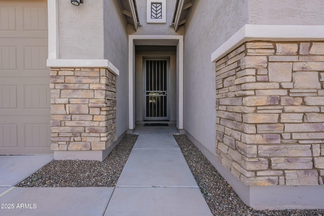 view of exterior entry featuring a garage