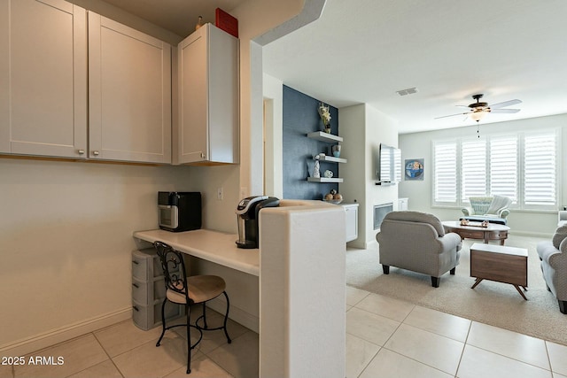 kitchen featuring light tile patterned floors and ceiling fan