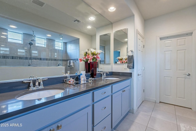 bathroom with vanity, tile patterned floors, and tiled shower