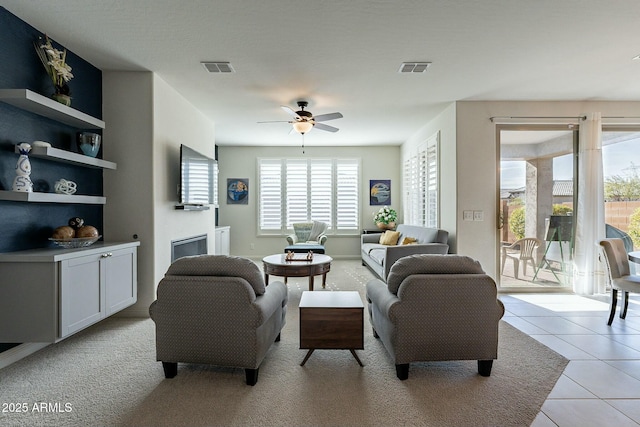 tiled living room with ceiling fan