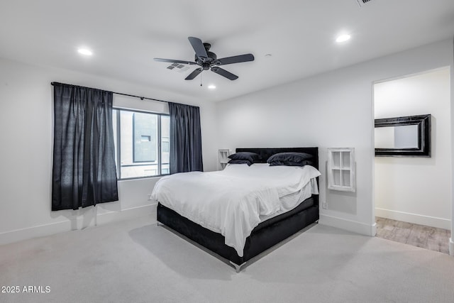 bedroom with ceiling fan and light carpet