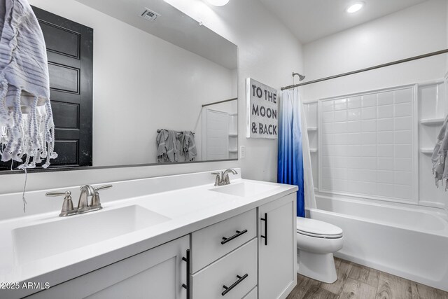 full bathroom with toilet, vanity, shower / bath combination with curtain, and hardwood / wood-style flooring