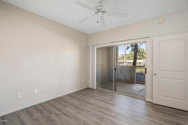 spare room featuring wood-type flooring and ceiling fan