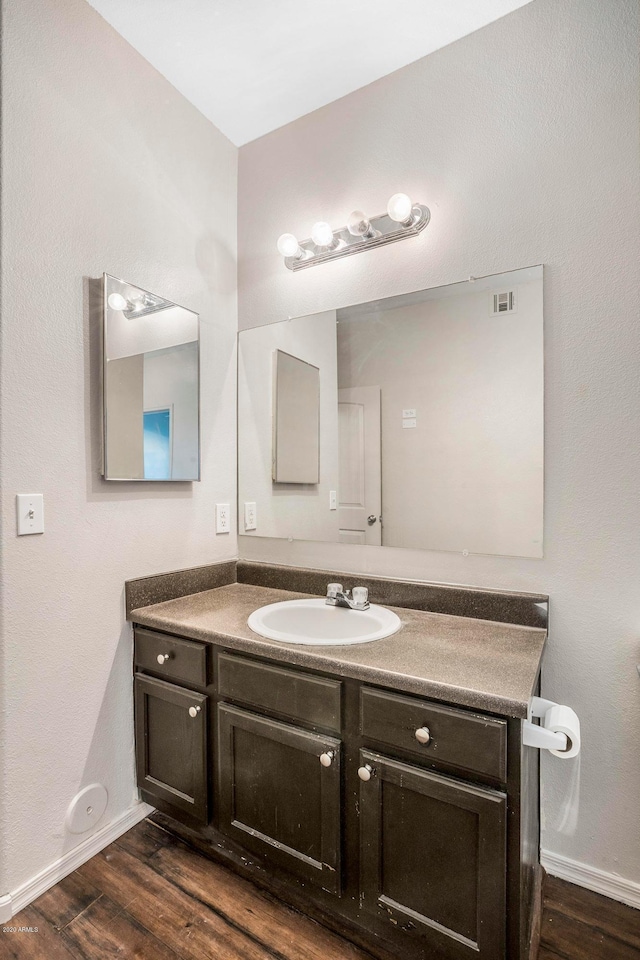 bathroom featuring vanity and hardwood / wood-style floors