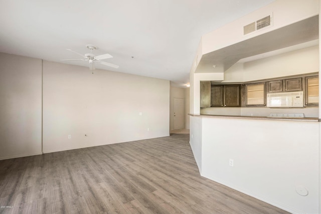 unfurnished living room with ceiling fan and light hardwood / wood-style flooring