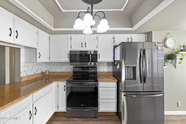 kitchen with dark stone countertops, stainless steel appliances, white cabinets, dark hardwood / wood-style flooring, and a chandelier