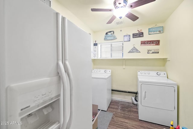 laundry area with washing machine and dryer, dark hardwood / wood-style floors, and ceiling fan