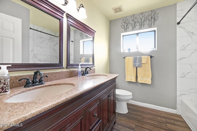 full bathroom with vanity, shower / bathing tub combination, wood-type flooring, and toilet