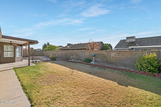 view of yard with a fenced in pool, ceiling fan, and a patio area