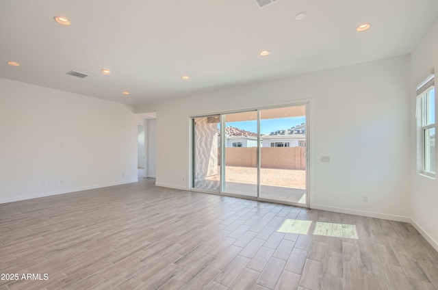 870 W Peralta Pass, Apache Junction, AZ 85120 - empty room with plenty of natural light, light wood-style floors, recessed lighting, and baseboards