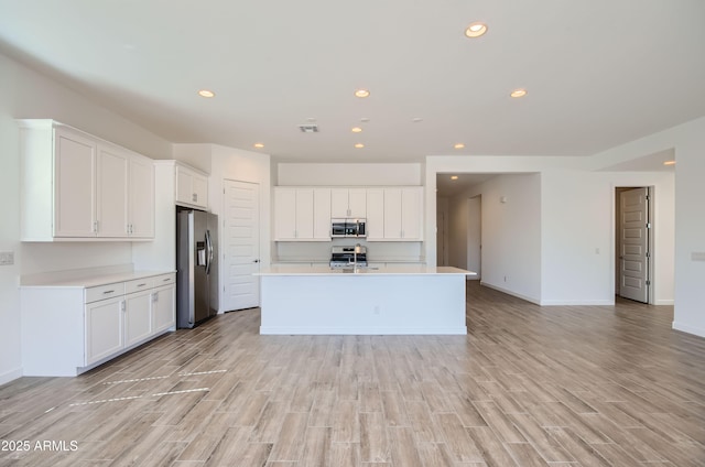870 W Peralta Pass, Apache Junction, AZ 85120 - kitchen with appliances with stainless steel finishes, recessed lighting, white cabinetry, light countertops, and light wood finished floors