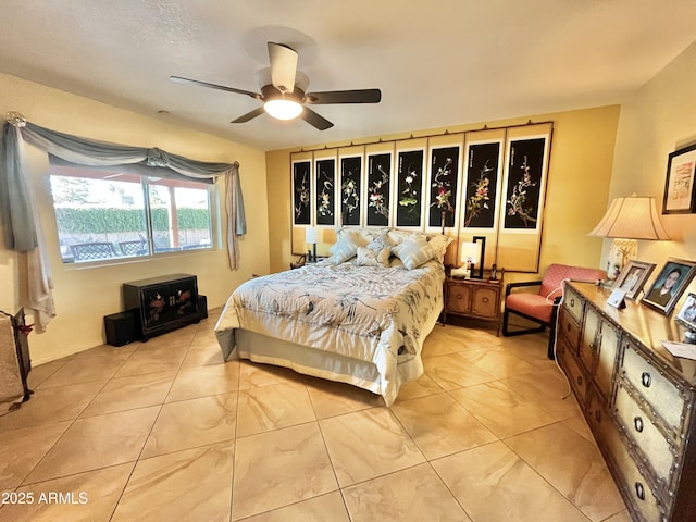 bedroom with ceiling fan and light tile patterned flooring